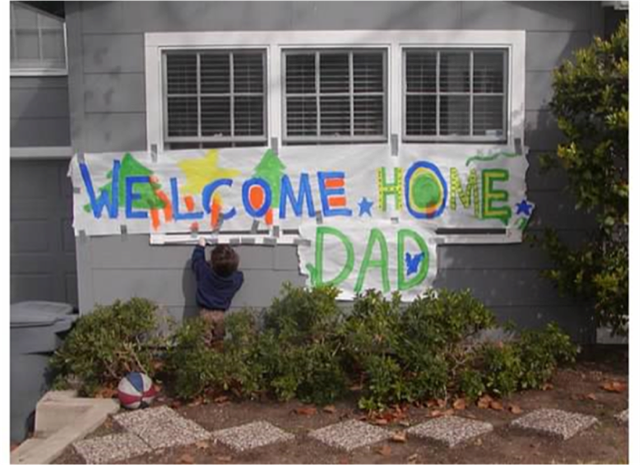 Sign on a house says “welcome home Dad”