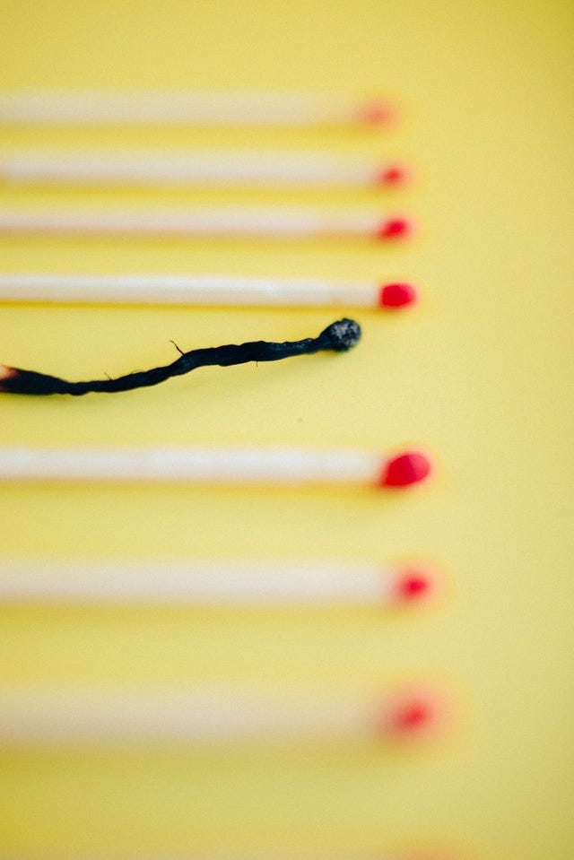 A match completely burned out among other unlit matches