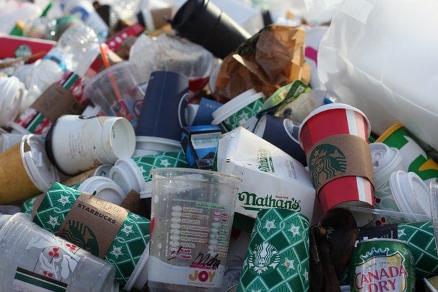 A pile of trash that includes food packaging.