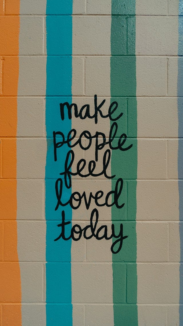Make People Feel Loved Today, written on a wall