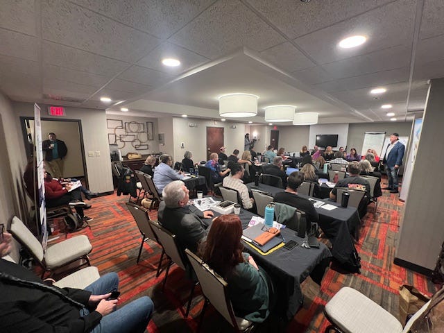 Achieve University from October 2024 displaying small group of business owners receiving business growth training from co-owner Robert Raymond in October 2024.