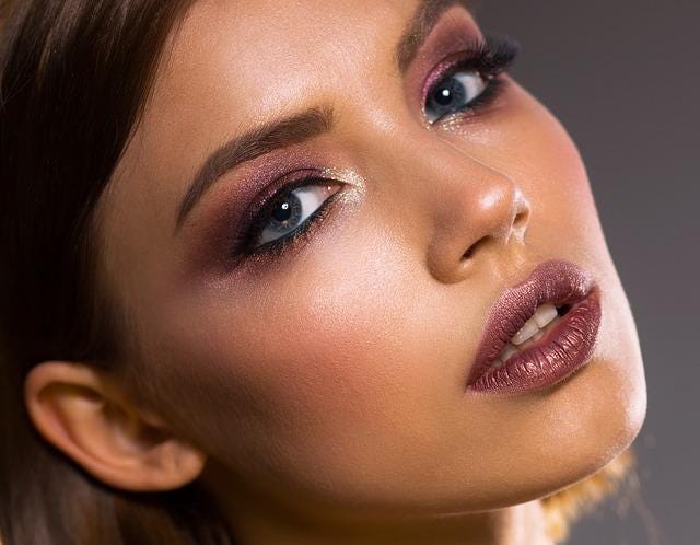 Woman with beautiful makeup, maroon eyeshadow and lipstick