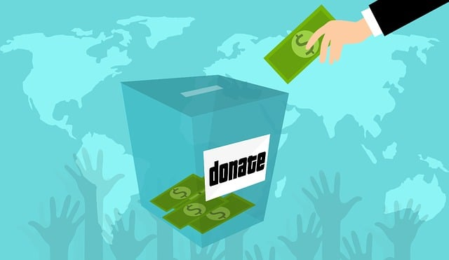 Graphic showing a hand dropping paper money into a donation box.