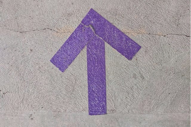 a purple up arrow