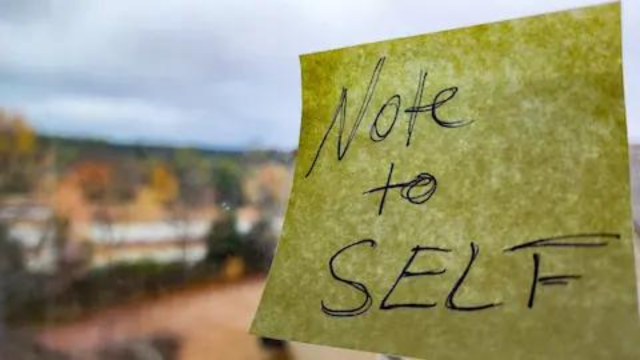 Sticky note on window looking out into the woods.