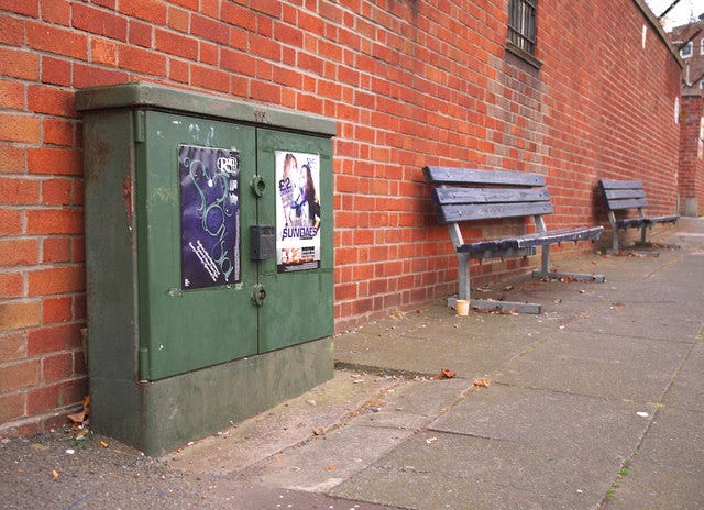 A BT junction box — a metal green bin or cupboard on a street corner.