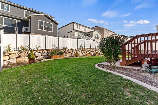 Layton Utah Home for Sale backyard with a landscaped garden and a serene ambiance…