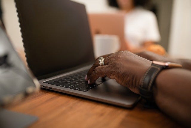 Woman typing on laptop