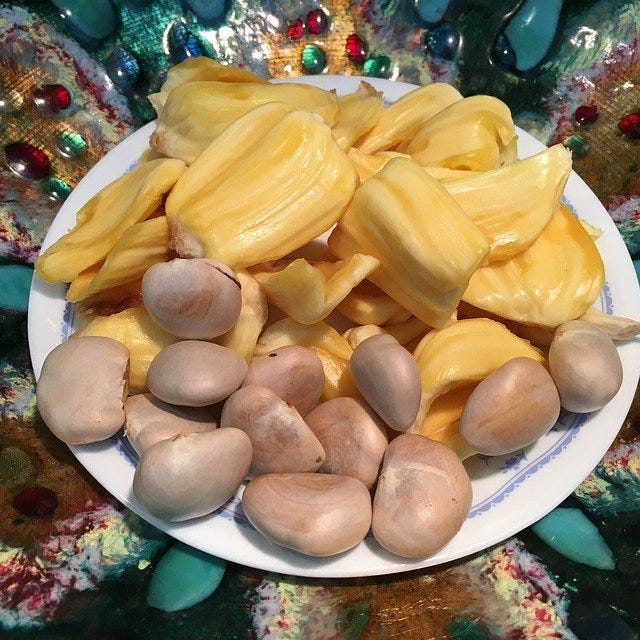 Close up of Jackfruit flesh and jackfruit seeds on a white plate