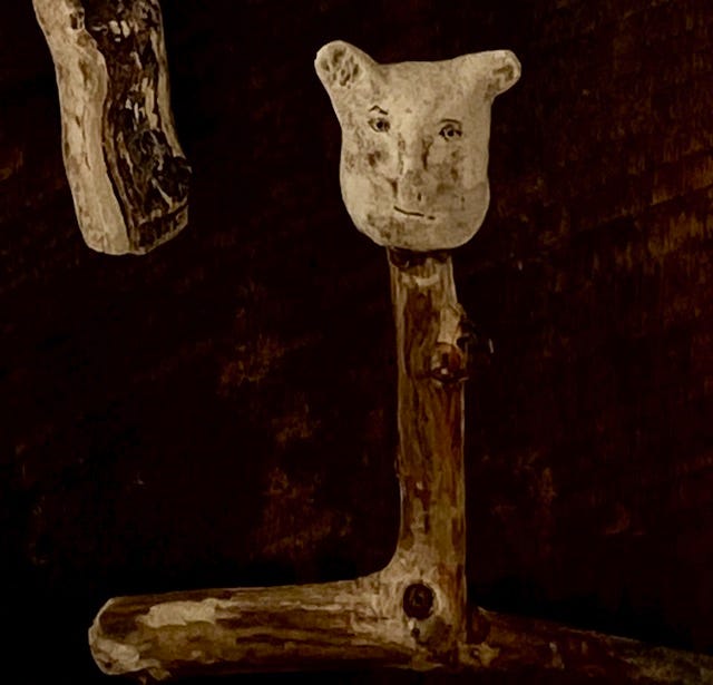 Small primitive ceramic heads on sticks