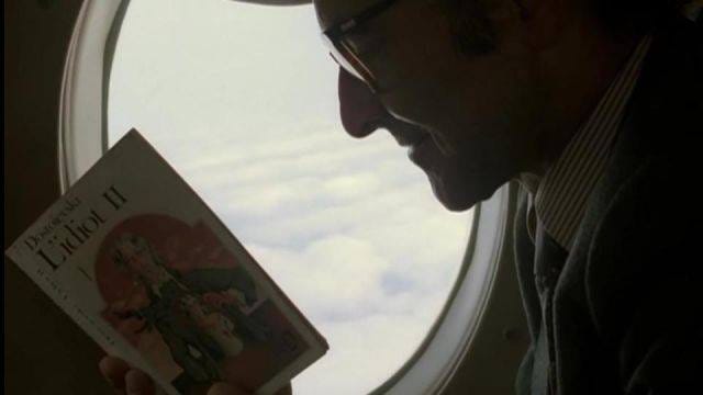 Godard reading Dostoïevski on a plane in his movie “Soigne ta droite”, 1986