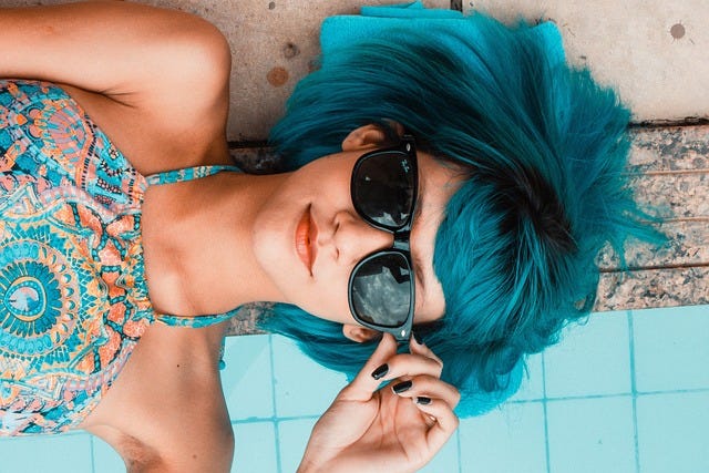 Blue haired girl wearing sunglasses