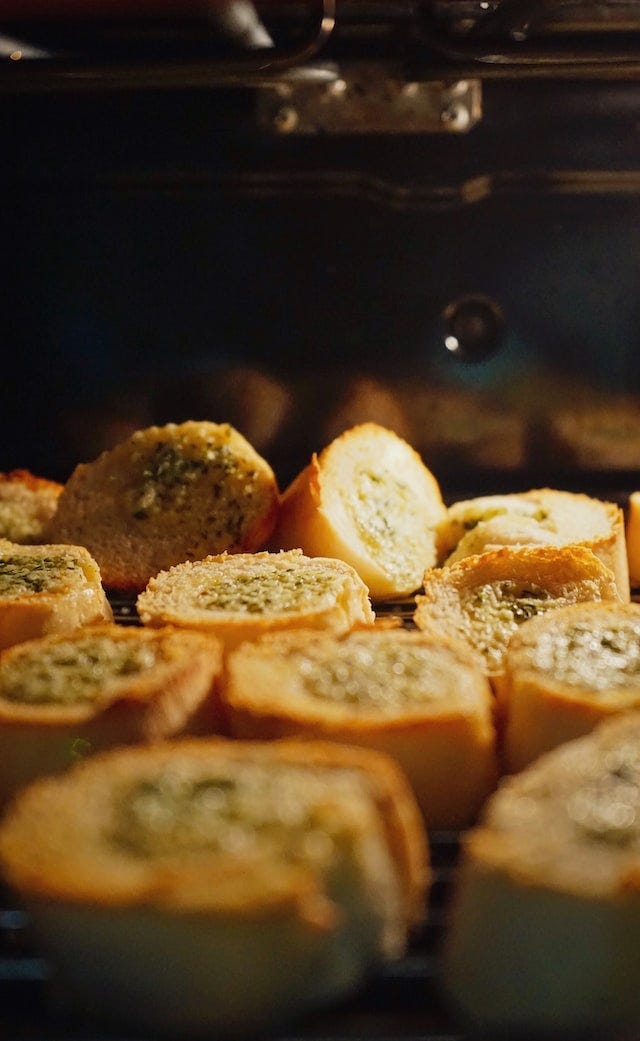 Garlic bread bites situated beside each other.