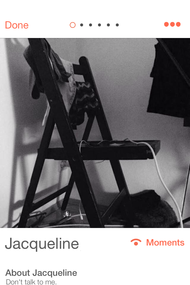 A screenshot of a Tinder profile from 2014 with a black-and-white picture of a chair with some clothes and a computer charger draped over it