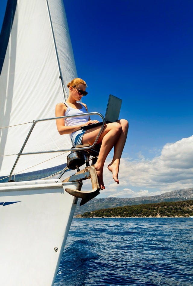 Girl using her laptop on a yatch