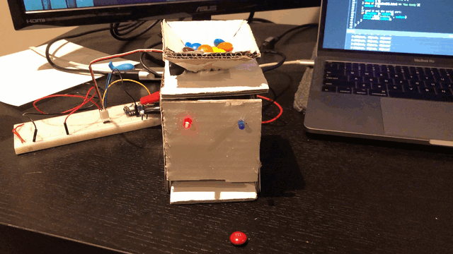 A cardboard box dispenses candy with voice control.
