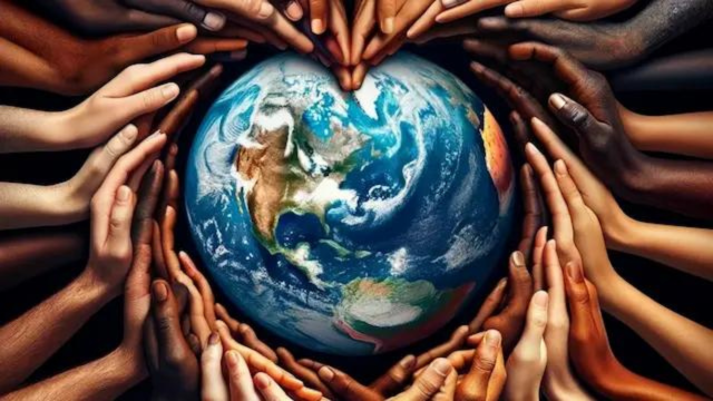 diverse hands of different races and ethnicities coming together to form a heart shape around the earth