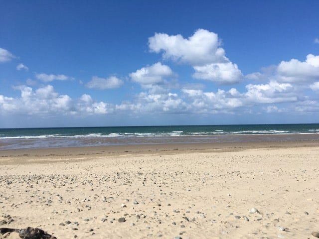 Photo of a beach with some stones