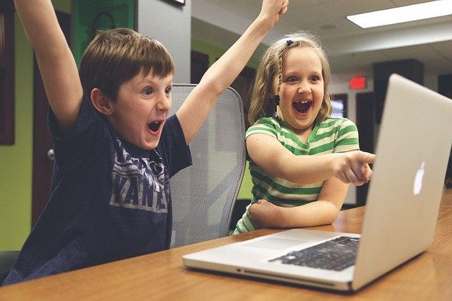 Image of children celebrating, depicting success.