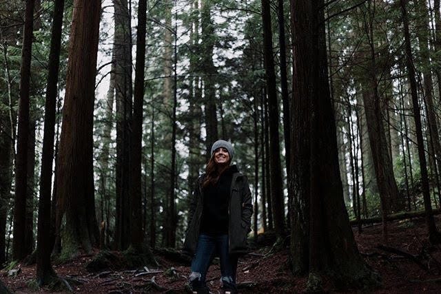 Katie standing in a forest