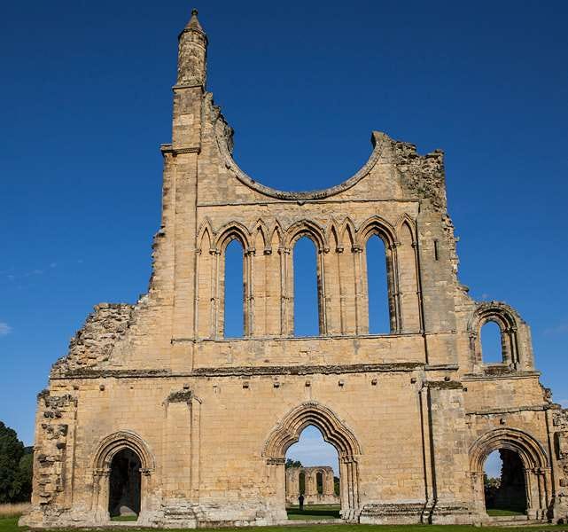 A photo of part of the ruins of Byland Abbey agaisnt a background of deep blue sky