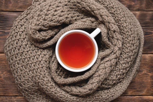 cup of tea wrapped in a sweater