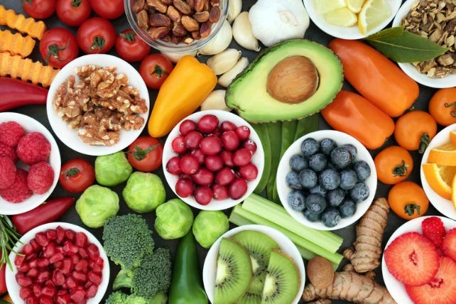 fruits, veggies, nuts on a table. “healthy foods”