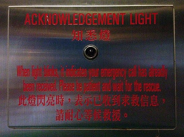 Acknowledgement light notice inside an elevator at Bowrington Road Cook Food Market, Hong Kong