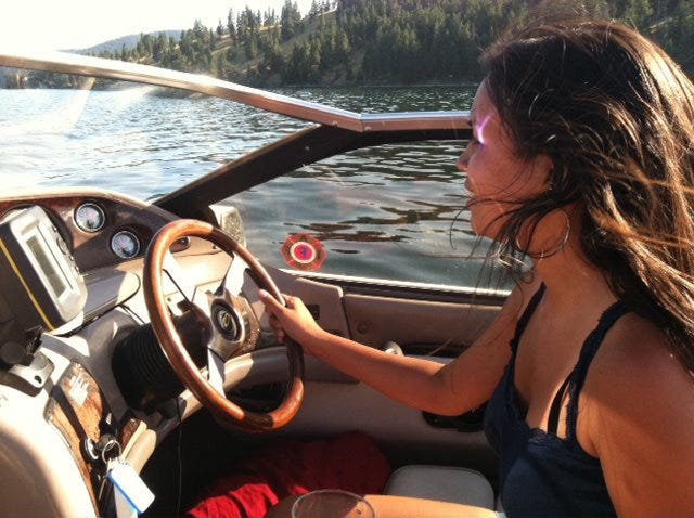 Maya driving Mario's boat on the Flathead Lake in Montana.