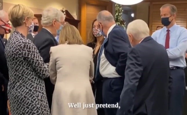 Nancy Pelosi talking on speaker phone on January 6th surrounded by members of congress.