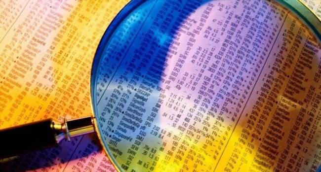 Close-up of a magnifying glass on a financial report