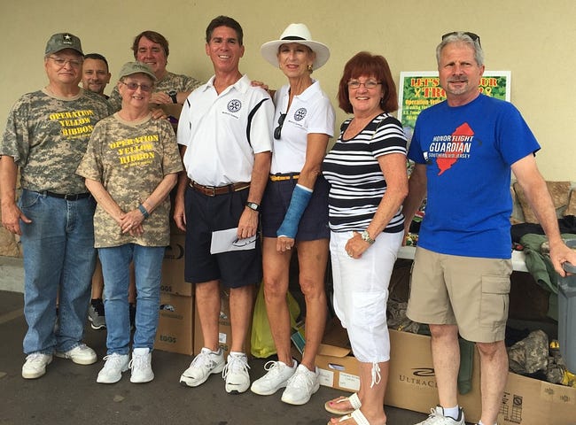 Members of Operation Yellow Ribbon stand beside Medford Sunrise Rotary members, center to right, Norman Mackey, Linda Mackey, Anne Carrel and Ed Martino.