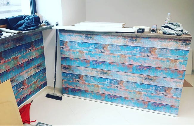 Juice bar counter with distressed wood design