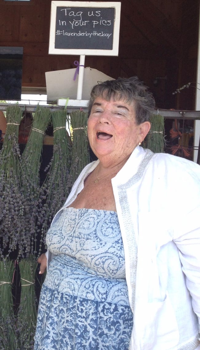 My beautiful friend Judy in front of a rack of freshly cut lavender