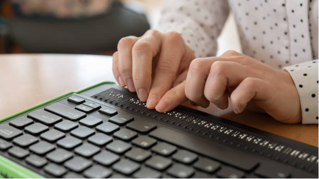 Photo of person using brail computer