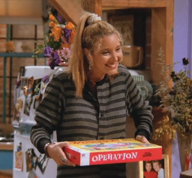 Phoebe Buffary wearing an off white scrunchie in a high ponytail, before getting ready to play the game Operation.
