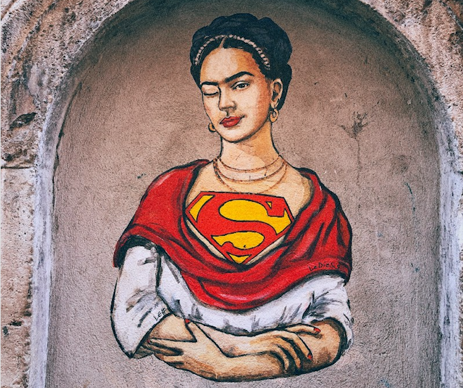 Painting of a woman baring the Superman symbol.