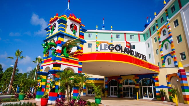 Entry and approach view of Legoland Hotel, located in Florida. A tall column built from giant Lego hides a dragon.