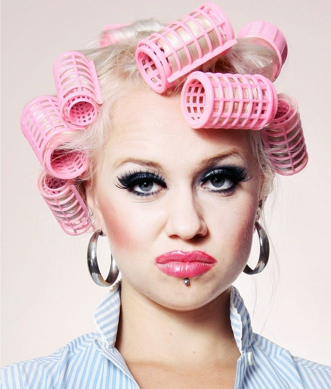 A woman in pink curlers makes her boundary clear with a nasty look.