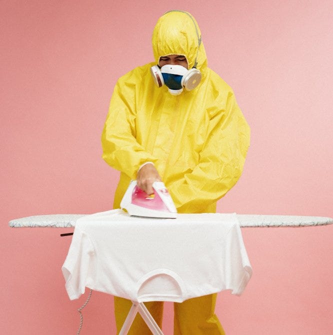 Person in yellow protective suit ironing tshirt - Starting a Business While Quarantined
