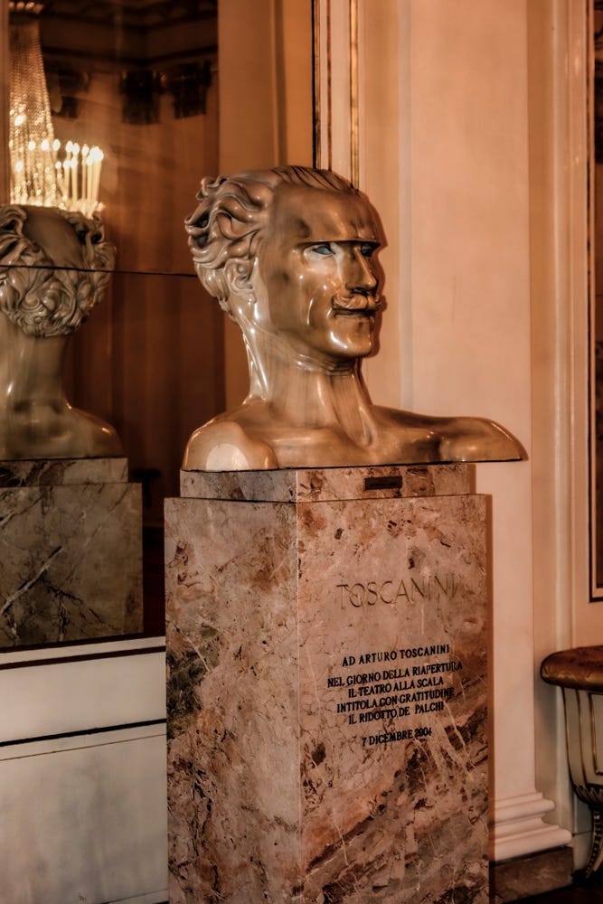 Bust of Arturo Toscanni on a marble pedestal inside the Teatro alla Scala.