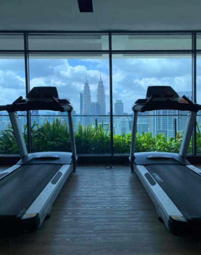 View of the Petronas Towers from a gym in a high-rise building