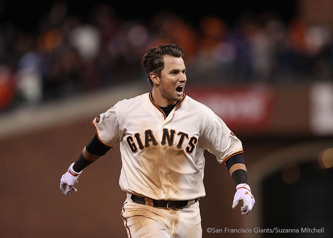 Joe Panik celebrates after doubling in the thirteenth inning to score Brandon Crawford for the winning run.