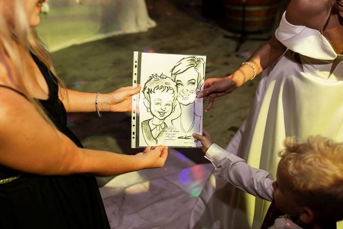 People holding a caricature