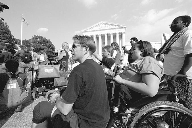 Kevin Irvine and Karen Tamley, longtime disability rights advocates, attend the March for Justice Rally in 2000. PC: Tim Olin