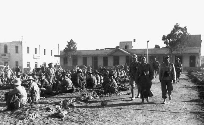 Erwin Rommel walking past British POWs (prisoners of war) in Tobruk.