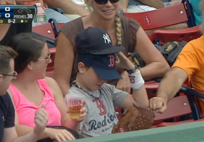 Red Sox fan wearing Yankees hat