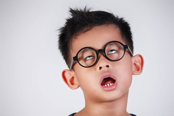 An image of a bored kid with his funny face.