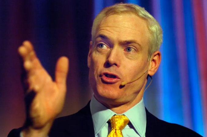 A picture of Jim Collins speaking to a large group of people.