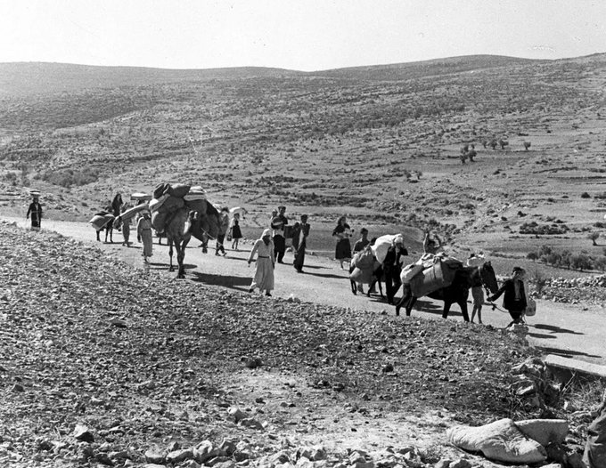 Fotografia em preto e branco de palestinos deixando a região em que viviam durante a Nakba em novembro de 1948